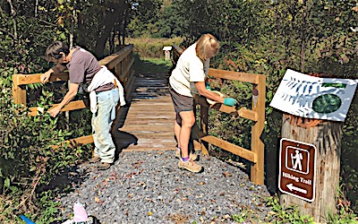 Lansing Pathways volunteers putting finishing touches on the new bridge. murdockspur entryway