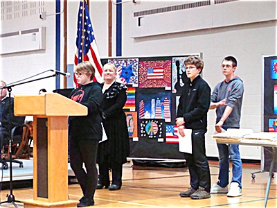 Three 8th graders read their answers to the question, "What does it mean to be an American?" Naturalizations