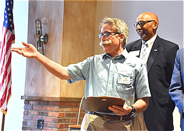 Ted Schiele accepts the annual Rotarian of the Year plaque at the June 29 Ithaca Rotary meeting rotary Schiele