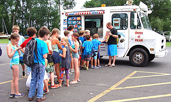 Camp Director Dan Cheatham holds the menu while day campers make their choises for free ice cream on the last day of camp last Friday Rec Department Day Camp