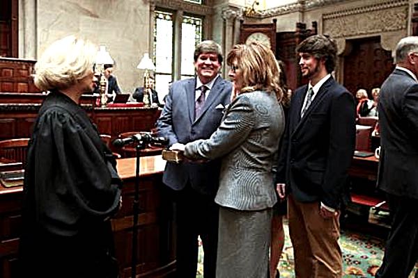NYS Senator Pam Helming is given the oath of office by New York State Court of Appeal Chief Justice Janet DiFiore, as her husband Gary holds the family Bible, and her son Evan and his girlfriend Sierra Johnson look on. helming swearingin
