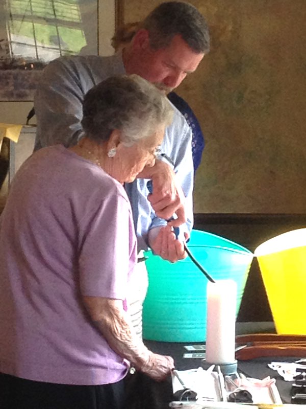 Gary Tyrrell and North Lansing Auxiliary President Irene Tyrrell lighting a candle in memory of departed North Lansing Auxiliary members Candle Lighting