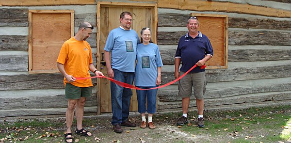 Robert North Baldus and Jane Ellen North Bryce (in blue T-shirts) came to Myers Park in 2010 for a ceremony commemorating the restoration of their ancestor Thomas North's log cabin North Log Cabin Dedication