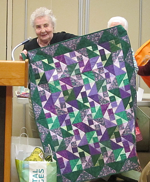 Marie Witzel with one of her donated ALS quilts quilters marie