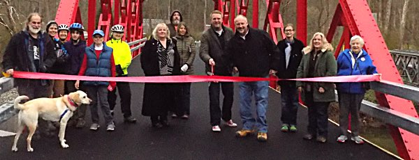 Tompkins County Legislator Mike Sigler (holding scissors) and Lansing Highway Superintendent Charlie 'Cricket' Purcell cut a red ribbon to celebrate the newly reopened Red Bridge, and the fact that it is red again after 55 years. Red Bridge