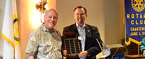 Ithaca Rotarian of the Year 2016-17 Scott Russell (left) receives the coveted plaque from Rotary President Dale Johnson, and make acceptance remarks during the year-end Pass the Gavel ceremony on June 28 rotary russell