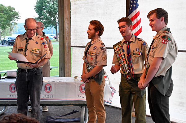 Rick Vaughn, Scout leader sharing letters of commendation with the Eagle Scouts (left to right) Nico Streb, Toby Green and Sean O'Neil scouts eagles 3