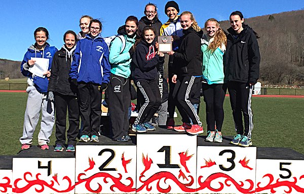Girls team atop the awards podium with their champions plaque at the Red, White, Blue, and Gold Invitational. Photoby Becca Lovenheim track teamwins