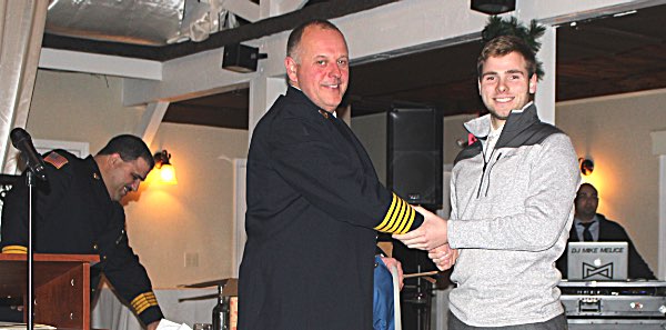 Kyle Steiner (right) is congratulated by Chief Scott Purcell for being the top lansing emergency responder for 2017. Kyle Steiner