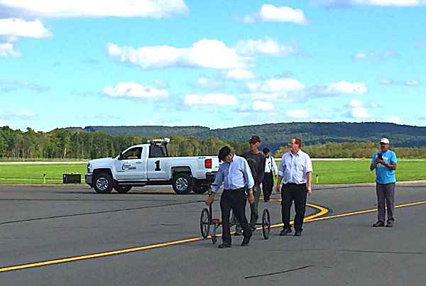 The ground crew returns a trolly used to pull Tommy around the airport, shortly after the takeoff Tommy Come Home Historic Centennial Flight Ithaca-Tompkins Airport September 29, 2018