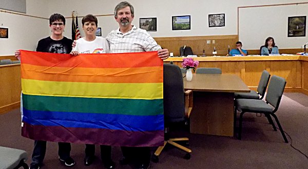 Deborah and Joanne Cipolla-Dennis present a rainbow flag to Lansing Supervisor Ed LaVigne Deborah and Joanne Cipolla-Dennis, Ed LaVigne