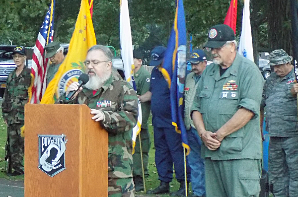 US Air Force veteran Chaplin Jerry Fulmer (left) offering a prayer while veteran and Watch Fire organizer Harvey Baker (right) stands with bowed head MIA/POW Watchfire in Myers Park September 21, 2018