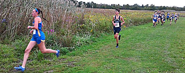 xc Catie Eisenhut rounds a muddy turn on way to breaking Lansing XC course record