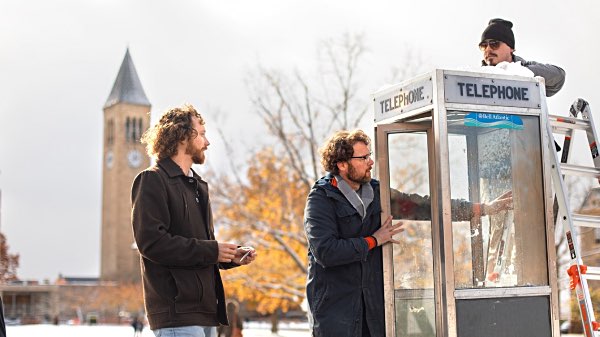 Photo by Jason Koski: Chris Hoff, left, and Sam Harnett install a listening booth on the Cornell Arts Quad cherry sound