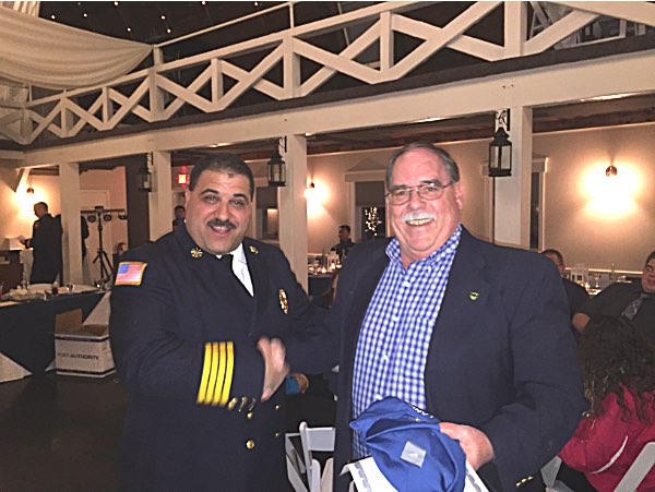 Deputy Chief Brad George congratulates former Chief Rick Drake (right) on 40 years of service to the Lansing Volunteer Fire Department Rick Drake
