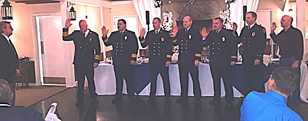 From left, Director of Tompkins County Emergency Lee Shurtleff swears in Lansing's 2019 officers: Chief Scott Purcell, Deputy Chief Brad George, Asst. Chief Todd Mix, Asst. Chief Joe Lisi, Captain Josh Nalley, Lieutenant Nelson Golden, and Lieutenant Gary Brooker. Lansing Fire Department 2019 Officers