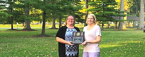 Crystal Howser (left) accepts congratulations from current Lansing Lions Club President Anne Drake lions uplinger awardee