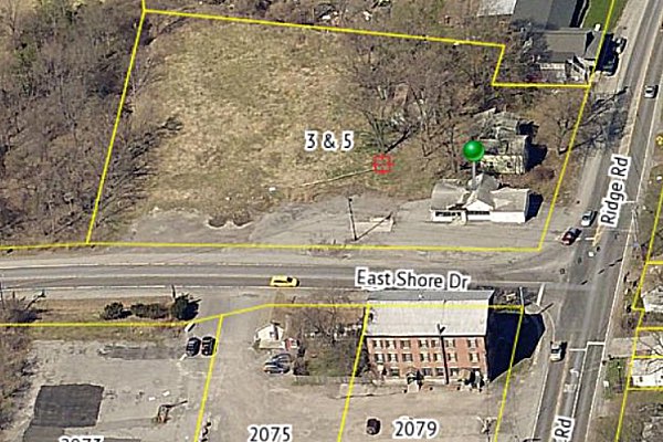 The applicant submitted an aerial view looking west, showing the property across the street from Rogue's harbor inn. Quality Sheds location