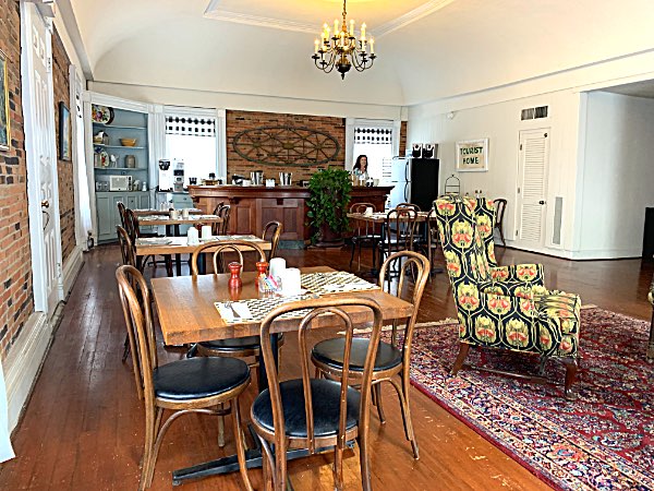 The historic ballroom on the third floor has been repurposed as a breakfast room with tables and casual seating areas Rogue's Harbor Ballroom
