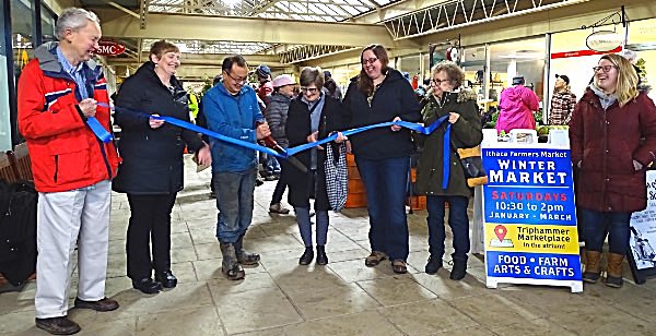 A ribbon cutting kicked off the Winter Ithaca Farmer's market Saturday at its new home in Triphammer Marketplace in the Village of Lansing. (Left to right)Village of Lansing Mayor Don Hartill, Tompkins Chamber President Jennifer Tavares, Stick and Stone Farm farmer Chaw Chang, retired agriculture and horticulture program leader at CCE-Tompkins Monika Roth, IFM market manager Becca Rimmel, Tompkins Chamber Ambassador Heidi Goldstein, IFM Marketing Coordinator Laura Gallup Ithaca Farmer's Market