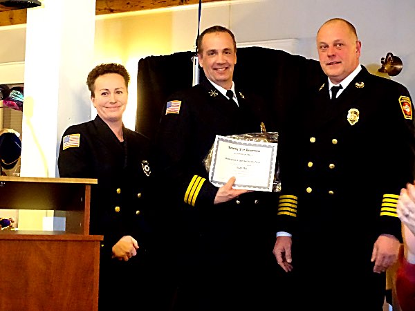 Todd Mix (center) received the EMS Dedication and Service Award from EMS Administrator Traci Lisi. Chief Scott Purcell is at right. Todd Mix