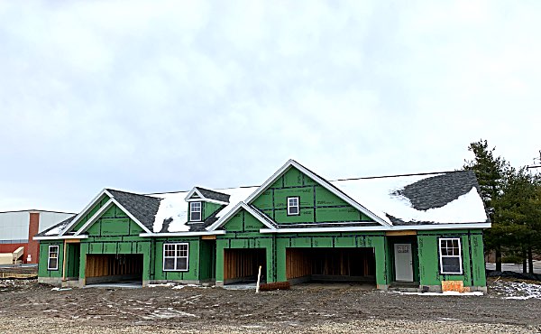 Each triplex has two end units with two-car garages, plus a slightly smaller middle unit with a one-car garage. Lansing Meadows