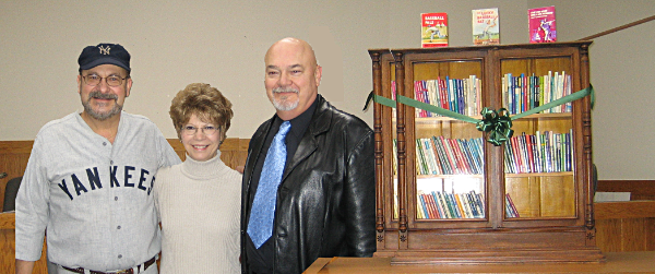 Matt Christopher's children (from left) Dale, Pamela, and Marty (Duane not pictured) donated his personal library of the books he authored to the Lansing Community Library in 2005. Matt Christopher's library