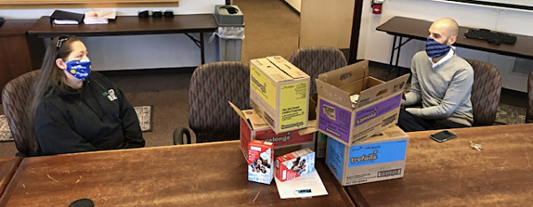 Kim Cook and Mike Smith with donated Girl Scout cookies at TCAT headquarters tcat cookies Kim Cook and Mike Smith