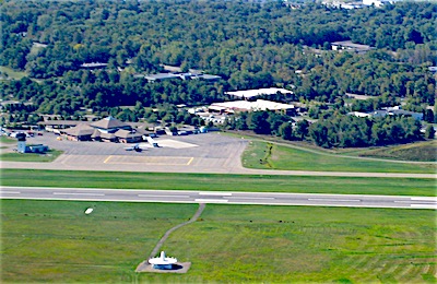 ITH has two runways. In this picture, if you look closely you can see the turf runway parallel to and almost touching the paved runway on the side closest to the VOR (VHF Omni Directional Radio Range) navigation beacon at the bottom of the image. ITH Runway Closing