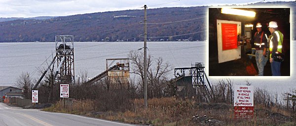 Mine Shafts (left to right) 3, 2 and 1 at the active Cargill Rock Salt Mine property between Myers and Portland Points. Shaft #1 is used to bring the road salt product to the surface. Shaft #2 is mostly inactive, while #3 is used every day to bring mine employees and equipment 2,300 feet below the surface to the deepest salt mine in the United States. The new Shaft #4 proposed for about seven miles north is a somewhat improved version of Shaft #3. Inset: the cave-like foyer miners see when they step off the elevator and enter the mine. Cargill Mine Shafts