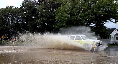 The Lansing Fire Department responds to an emergency during a 2014 flood emergency flood fire 2014 400